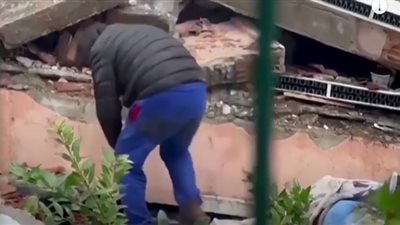 لقطة إنسانية لشخص يساعد محاصرين تحت الأنقاض بزلزال تركيا