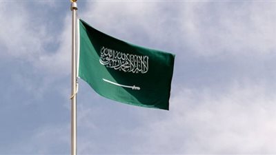 مسنة تتسلق حائط منزلها لرفع راية التوحيد في يوم العلم